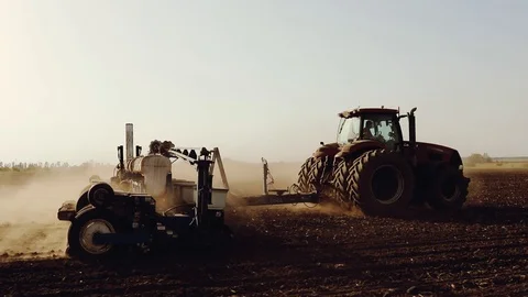Tractor pulls the seed drill, agricultural machinery seeder. Stock Footage 93304162