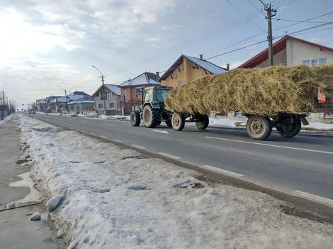 A tractor pulls a trailer loaded with hay - Maramures, Romania Фото