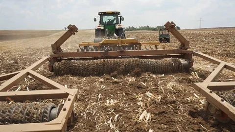 A tractor pulls a wide plow Stock Footage 93967722