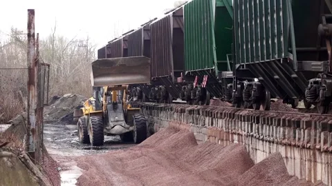 The tractor pushes the wagons with a bucket. Stock Footage 196087429