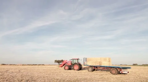 A tractor pushing a haystack trailer. Stock Footage 27480400