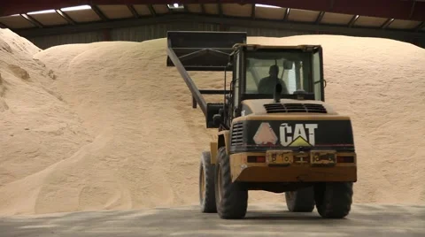 Tractor pushing rice for rice mountain in warehouse Stock Footage 63153322