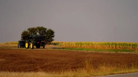 Tractor raising dust beside a tree line near Lebanon Stock-Footage 345530625
