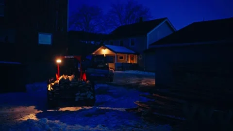 Tractor with Rear Attachment Bucket Full of Cut Logs at Night Stock-Footage 347689753