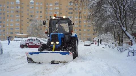 Tractor removes snow from the road after snowfall Stock Footage 85468730