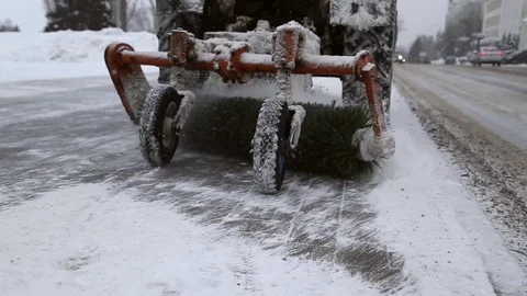 A tractor removes snow from the sidewalk Stock Footage 72692739