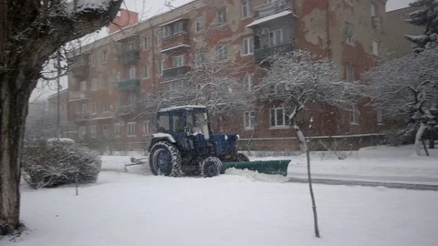 Tractor Removing Snow With Plow. Snowblower Removes Snow From the Walkway With Stockbeeldmateriaal 71438796