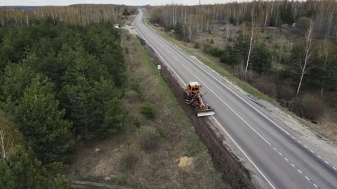 Tractor repairs road view from a height. 4k footage Stock Footage 168199687