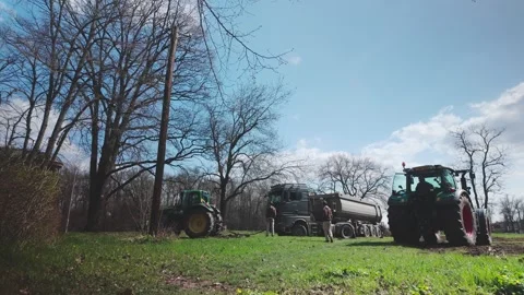 Tractor rescue pulls stuck lorry from muddy field on rural farmland. Stock Footage 306372002