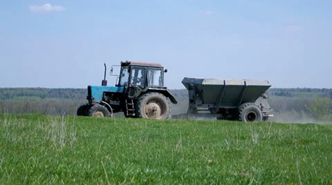 Tractor rides on the field Video stock 37833753