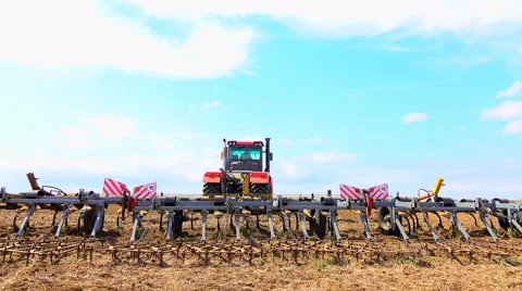 Tractor rides on the field Video stock 62784212