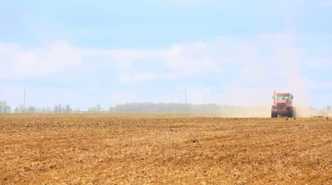 Tractor rides on the field Stock Footage 62784448