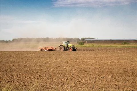 Tractor rides on the field Stock Photos