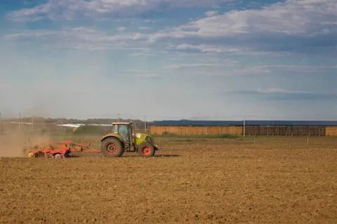 Tractor rides on the field Fotos de archivo