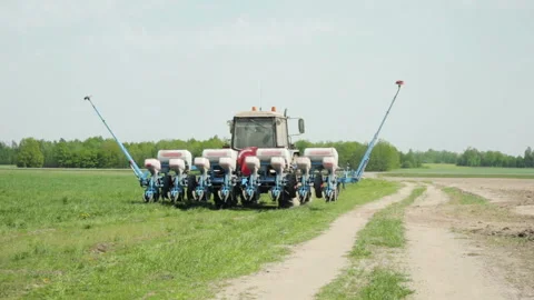 Tractor rides with the sowing unit Stock Footage 89779319