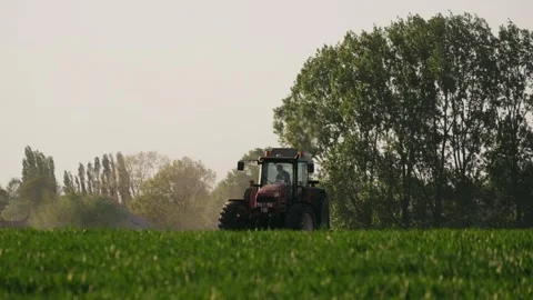 Tractor riding in a field, dust 스톡 동영상 289316745