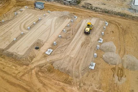 Tractor roller ramming the ground for a construction site top view. Stock Photos