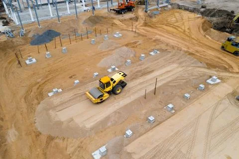 Tractor roller ramming the ground for a construction site top view. Stock Photos