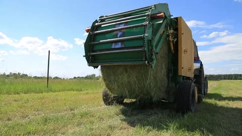 TRACTOR ROLLS HAY IN ROLLS Stock Footage 158127427