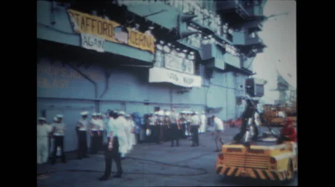 Tractor rolls up with television camera and man on hood on the deck of USS Wasp Stock Footage
