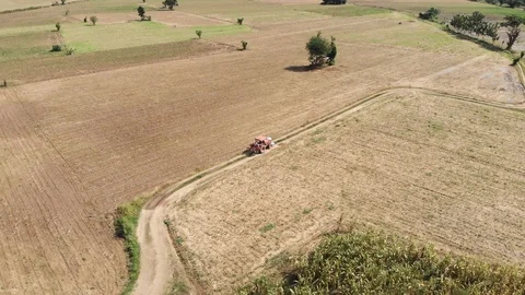 Tractor running through empty crop field Stock Footage 95939525