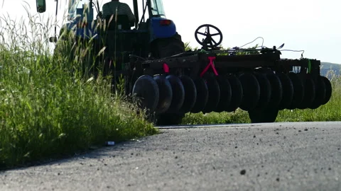 Tractor runs an asphalt at the end of workday Stock Footage 236726512
