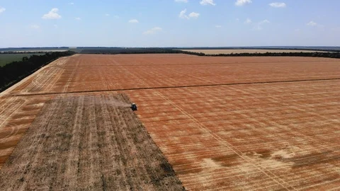 Tractor runs on the field in the spring Stock Footage 127516997