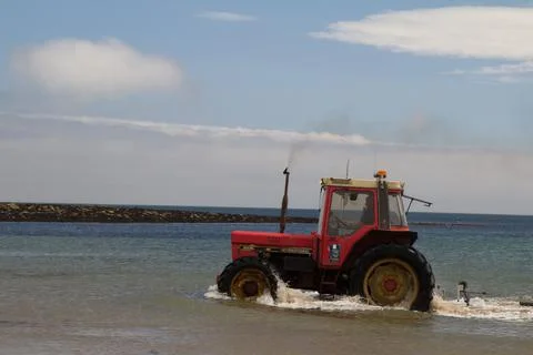 A tractor in the sea Stock Photos