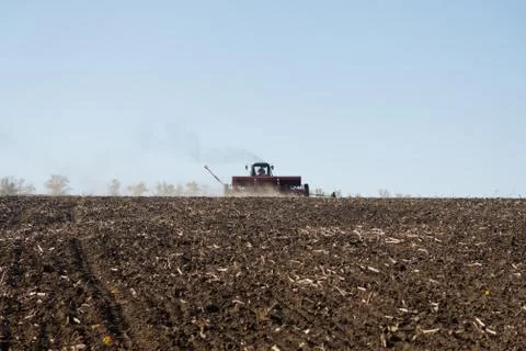 Tractor with a seeder on the field Stock Photos