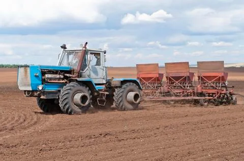 Tractor with seeder Stock Photos