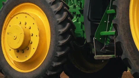 Tractor with seeder rides through green field Vídeos de archivo 240750377