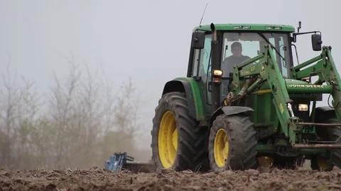 Tractor seeding far away Stock Footage 83474318