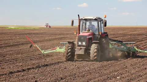 Tractor seeding on a field Stock Footage 22642116