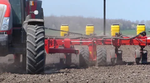 Tractor seeding on a field Stock Footage 26218187