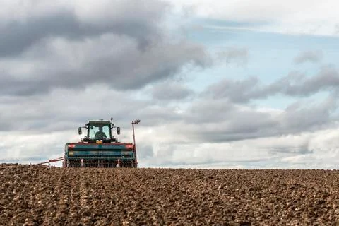 Tractor seeding in a field Stock Photos