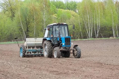 Tractor seeding the field Stock Photos