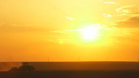 Tractor seeding plantation. Sunset sky on background. Static shot. Stock-Footage 107089209