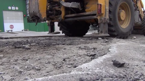 The tractor sets the stops on the ground for stability when working Stock Footage 148814990