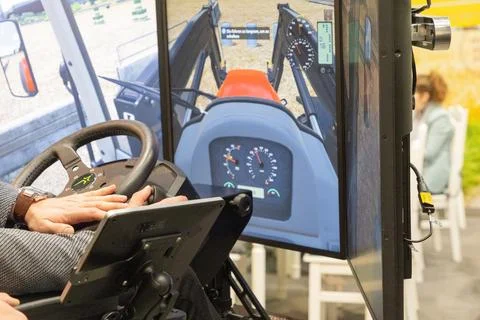 Tractor simulator with user operating controls and digital display screen Stock Photos