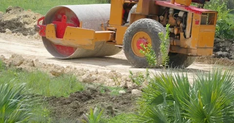 Tractor skating rink rams the ground for laying asphalt. Stock Footage 216211056