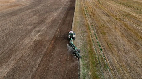 Tractor on Soil cultivation at field. Disk harrow on plowing field. Stock Footage 219868317