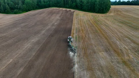 Tractor on Soil cultivation at field. Disk harrow on plowing field. Stock Footage 219868360