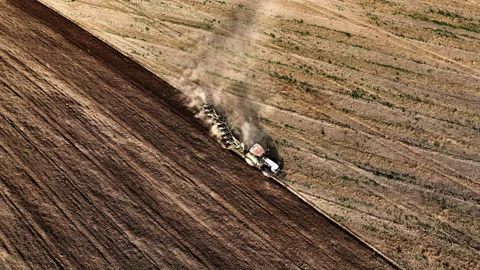 Tractor on Soil cultivation at field. Disk harrow on plowing field. Stock Footage 220102358