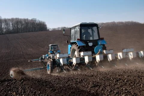Tractor with sower on the field Stock Photos