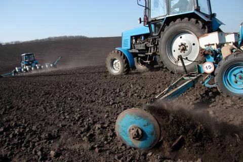 Tractor with sower on the field Stock Photos