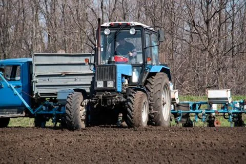Tractor with sower on the field Stock Photos