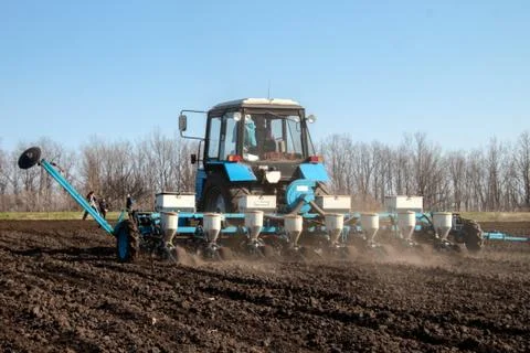 Tractor with sower on the field Foto stock