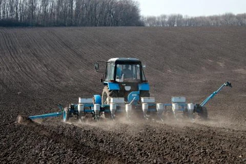 Tractor with sower on the field Stock Photos
