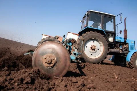 Tractor with sower on the field Stock Photos