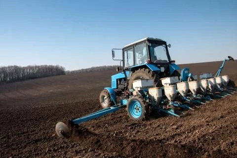 Tractor with sower on the field Stock Photos
